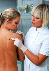 Dermatologist Inspecting the Skin on a Woman's Back