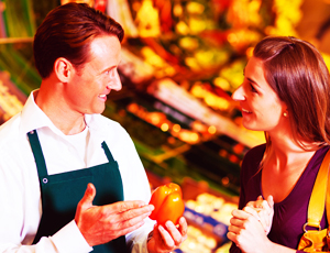 Grocer Speaking With Woman Customer