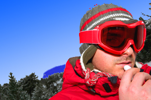 Man Applying a Lanolin Based Lip/Skin  Balm on Ski Slope