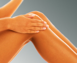 Woman Rubbing a Lanolin Based Skin Moisturizer on Very Smooth Legs